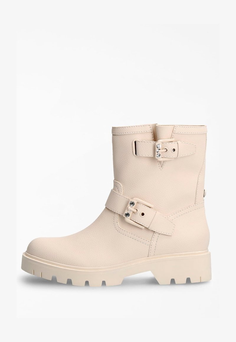 Beige leather ankle boot with two adjustable buckles, textured surface, rounded toe, and chunky rubber sole with distinct tread pattern.