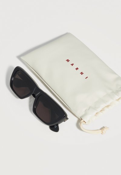 Black oversized rectangular sunglasses next to an off-white drawstring pouch with "MARNI" printed in red letters.