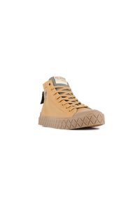 High-top canvas sneakers in tan with a textured rubber sole, featuring green accents, a logo patch on the tongue, and laced design.
