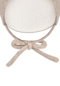 Felt hat in beige with a soft inner lining. Features a fabric tie that forms a bow at the base, creating a snug fit and decorative detail.