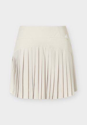 Beige plisseret nederdel med bredt linning og lille Adidas-logo øverst til højre, vist fladt mod hvid baggrund.