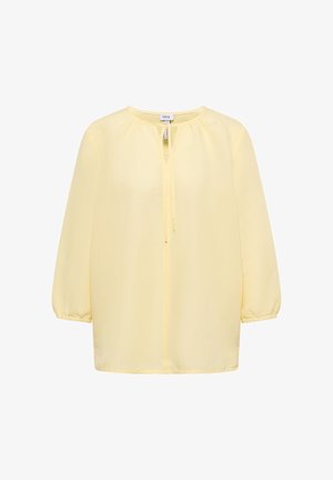 Lichtgele blouse met lange mouwen, ronde hals, strikdetail aan de voorkant en elastische manchetten van het merk Cecil, weergegeven op een witte achtergrond.