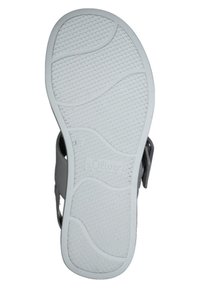 Graue Sandalensohle mit strukturiertem Gummi für Grip, ausgestattet mit wellenförmigen Mustern und Branding. Weiße Unterseite mit Mustern verbessert die Traktion.