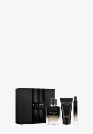 Czarny i złoty zestaw upominkowy Elie Saab L'Homme z flakonem perfum, tubką balsamu po goleniu, spray'em podróżnym i pasującym pudełkiem na białym tle.