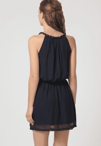 Vestido sin mangas de color azul marino con un escote fruncido, cintura elástica y dobladillo transparente. Presenta detalles trenzados en las tirantes.