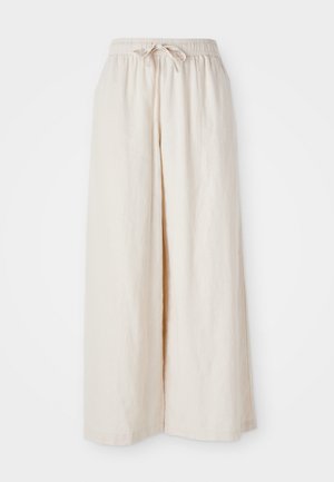 Široké krémové nohavice s elastickým pásom a šnúrkou. Hladká, ľahká ľanová tkanina, bez viditeľných vzorov alebo kovových doplnkov.