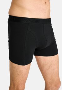 Sorte boxer briefs lavet af blødt stof, med en logo-elastik i taljen og en tætsiddende pasform, med flade sømme og et sømløst design.