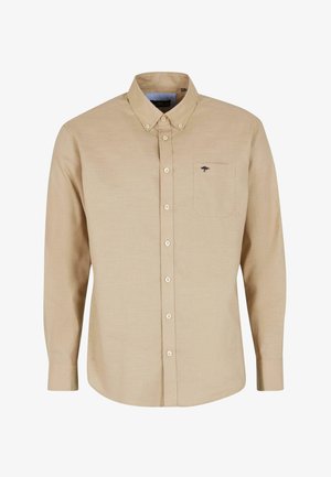 Beige hosszúujjú gombos ing sima anyagból. Gallérral, gombos elülső résszel és egy kis zsebével rendelkezik, amelyen egy fa logó található.