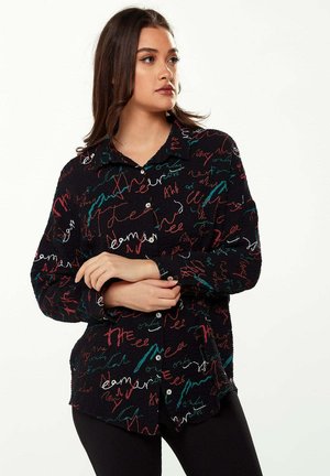 Black button-up shirt featuring a textured fabric with colorful, abstract handwriting patterns in red, teal, and white.