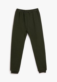 Pantalones de chándal de cintura elástica en verde oscuro con puños acanalados, dispuestos en plano sobre un fondo blanco.