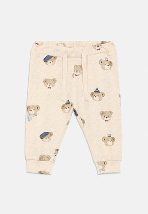 Pantalon beige pour tout-petits avec taille élastique et cordons, décoré de différents visages d'ours portant des chapeaux, des lunettes et des écharpes.