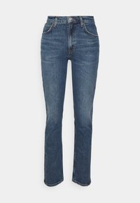 Vyötäröhousut sinisistä farkkukankaasta, joissa on hieman kapeneva lahje, klassinen viiden taskun malli ja hillitty rypistysyksityiskohta.