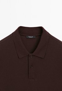 Dark brown textured polo shirt with two buttons and a classic collar, labeled Massimo Dutti, made in China.
