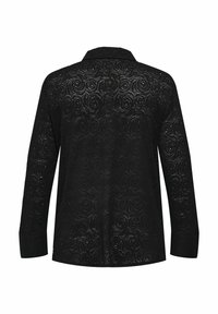Blouse noire avec un motif texturé de motifs tourbillonnants, manches longues et col classique, fabriquée en dentelle transparente.