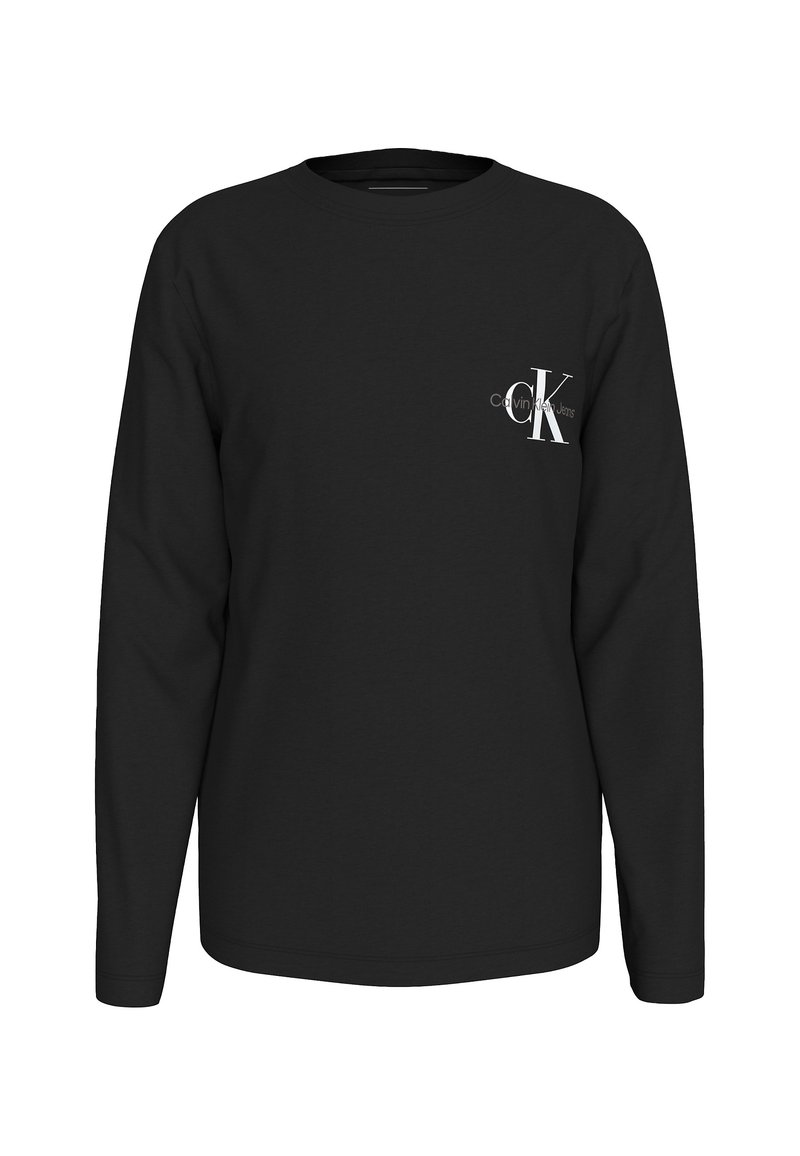 T-shirt noir à manches longues en coton. Présente un petit logo blanc Calvin Klein sur la poitrine. Encolure classique et coupe droite.
