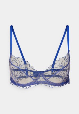 Sininen pitsinen bralette, jossa on kukkakuviointi. Varustettu säädettävillä satiinihihnoilla ja uurteellisella reunasuunnittelulla.