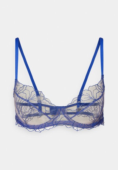 Sininen pitsinen bralette, jossa on kukkakuviointi. Varustettu säädettävillä satiinihihnoilla ja uurteellisella reunasuunnittelulla.