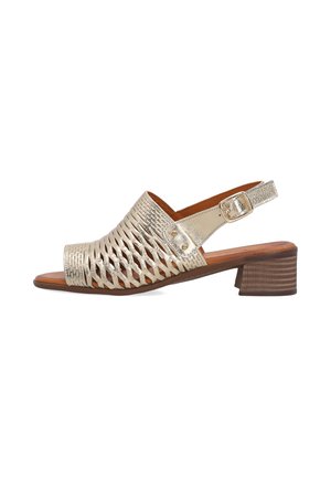 Metallic gold open-toe sandal with woven upper, adjustable buckle strap, and low block wooden heel.