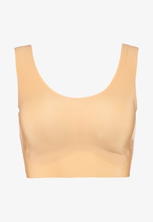 Beige trådløs bh med brede skulderstropper, sømløst design, glat tekstur og en buet halsudskæring. Subtilt brandlogo på siden.