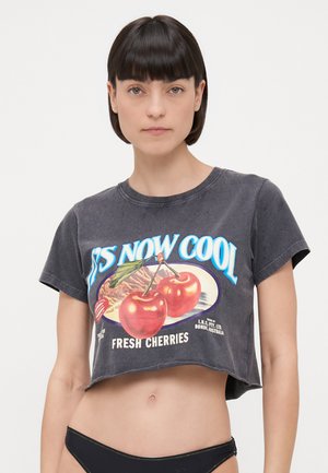 Gray cropped t-shirt made of cotton, featuring a colorful graphic design of cherries and the text "FRESH CHERRIES" and "IT'S NOW COOL."