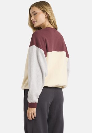 Pullover sweatshirt in rood, crème en grijs. Heeft een ronde hals, lange mouwen met ribgebreide manchetten en een relaxte pasvorm.