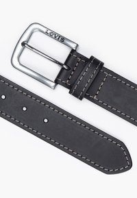 Black leather belt with silver metal buckle marked "Levi's." Features contrasting beige stitching and multiple adjustment holes.