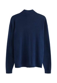 Granatowy sweter z długim rękawem i wysokim ribbowanym kołnierzem, o luźnym kroju. Gładka faktura i brak widocznych wzorów lub elementów metalowych.