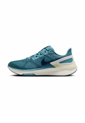 Scarpa da corsa in rete teal con un design elegante, caratterizzata da un logo Nike blu scuro, suola ammortizzata e tallone testurizzato per supporto.