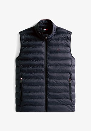 Tumesinine puffer-liiv, millel on horisontaalne tikandmuster, kõrge krae, esikinnis tõmblukuga ja kaks küljetaskut, mis on varustatud stiilsete mustade tõmblukkudega.