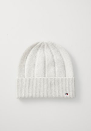 White knit beanie with a folded ribbed cuff, featuring a small tri-color logo accent. The texture is soft and slightly fuzzy.