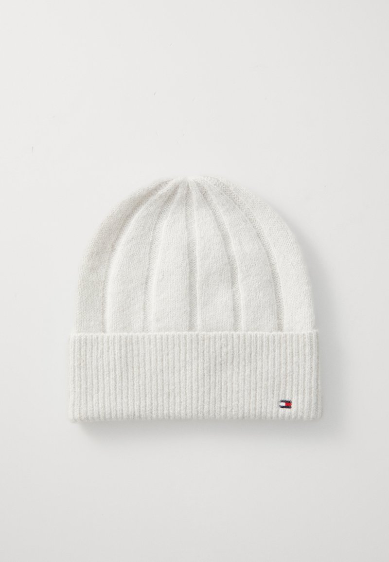 Bonnet en tricot blanc avec un revers côtelé, orné d'un petit logo tricolore. La texture est douce et légèrement duveteuse.