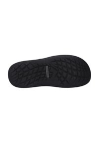 Black rubber shoe sole featuring a textured, diamond-patterned grip surface and a small logo near the center. Designed for traction.