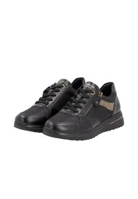 Black sneakers featuring a mix of smooth leather and fabric, accented with a gold side zipper and a beige stripe, set on a rubber sole.