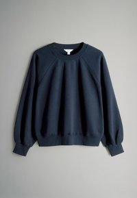 Navy blue sweatshirt with ribbed neckline and cuffs, textured fabric, and raglan sleeves. Features a rounded hem and minimal branding.