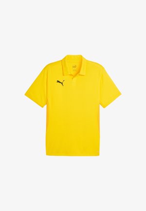 Żółta koszulka polo wykonana z oddychającego materiału, z klasycznym kołnierzykiem, krótkimi rękawami i czarnym logo Pumy po lewej stronie klatki piersiowej.