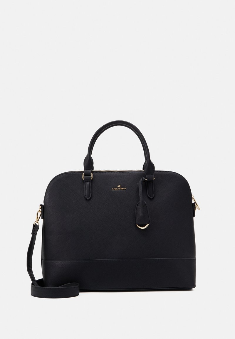 Sac à main structuré noir avec double poignée, bandoulière amovible, ferrures dorées et petit logo de marque centré à l'avant.