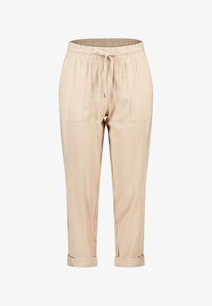Beige schmal geschnittene Hose mit einem elastischen Bund und verstellbarem Kordelzug. Verbunden mit zwei frontalen Taschen und umgeschlagenen Säumen. Glatte Stoffstruktur.