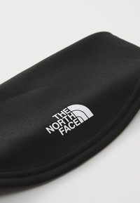Black neoprene case featuring a white logo of The North Face, smooth texture, rounded shape, and minimalistic design.