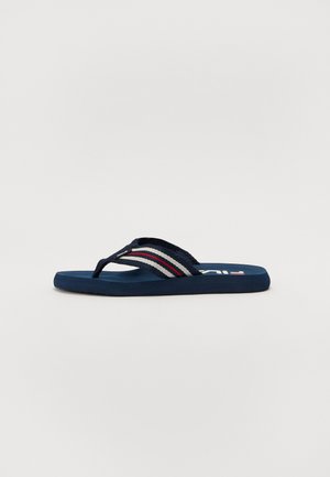 Navy flip-flop with textured strap featuring red, white, and grey stripes. Flat rubber sole designed for casual wear.
