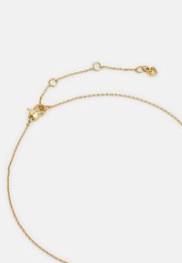 Gold chain necklace with a delicate linked design, featuring a lobster clasp and adjustable chain for length versatility.