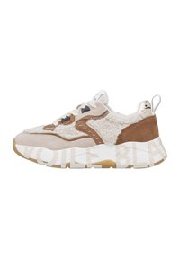 Beige and brown sneaker with shearling details, white laces, thick white sole with beige text, and pull tab on heel against white background.