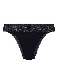 Tanga en dentelle noire avec un motif floral, des bords festonnés et un détail de nœud central à l'avant. Texture douce et transparente sur l'ensemble.