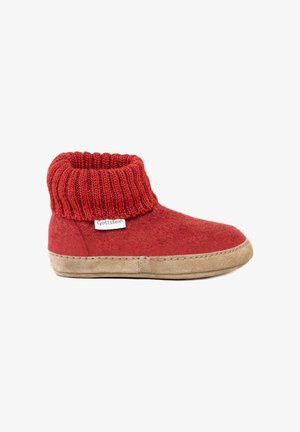 Red slipper with knitted cuff and beige sole, labeled "Gottstein," designed for indoor comfort and warmth.