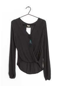 Black long-sleeve blouse with a deep V-neck, gathered waist, and adjustable tie with tassels. Made from lightweight, textured fabric.