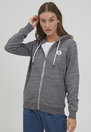 Gray zip-up hoodie made from knitted fabric, featuring a white drawstring, front pockets, and a circular logo on the left chest area.