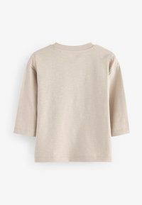 T-shirt en coton beige à manches trois-quarts, avec un col rond et une finition texturée. L'ourlet est droit sans motifs.