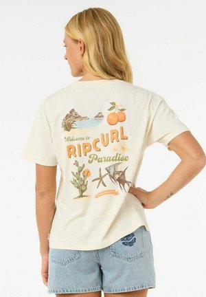 Cream-colored t-shirt featuring a printed graphic with beach elements and “Welcome to RIP CURL Paradise” text on the back.