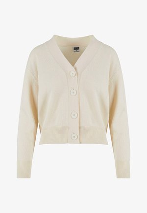 Cardigan cropped beige chiaro realizzato in morbido tessuto, con scollatura a V, polsini a costine e quatro grandi bottoni sul davanti.