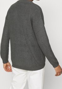 Gray knitted sweater with a textured pattern, crew neck, and long sleeves. Features ribbed cuffs and hem, shown from the back.
