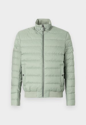 Padded jacket in light green with a high collar, front zip, and two side pockets. Features horizontal stitching and ribbed hem and cuffs.